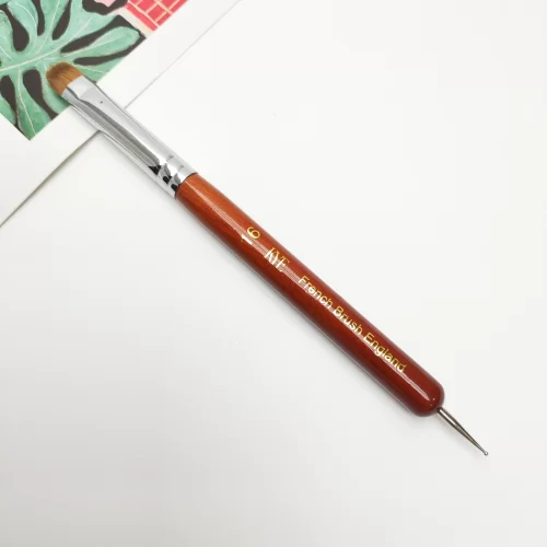 A KYE French Brush with Dotting Tool with a wooden handle used for painting on a piece of paper.