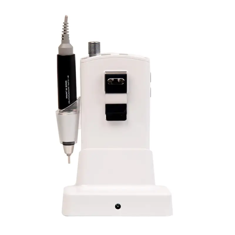 The ManiPro Passport Next Complete White, a sleek white dental handpiece with a black handle, rests elegantly on its charging base.