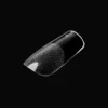 Against a black background, the black and silver metallic nail design on a single fingernail shines brilliantly, enhanced by the sleek elegance of Kupa ENRICHRx Sof Gel Tips 550ct. SQUARE.